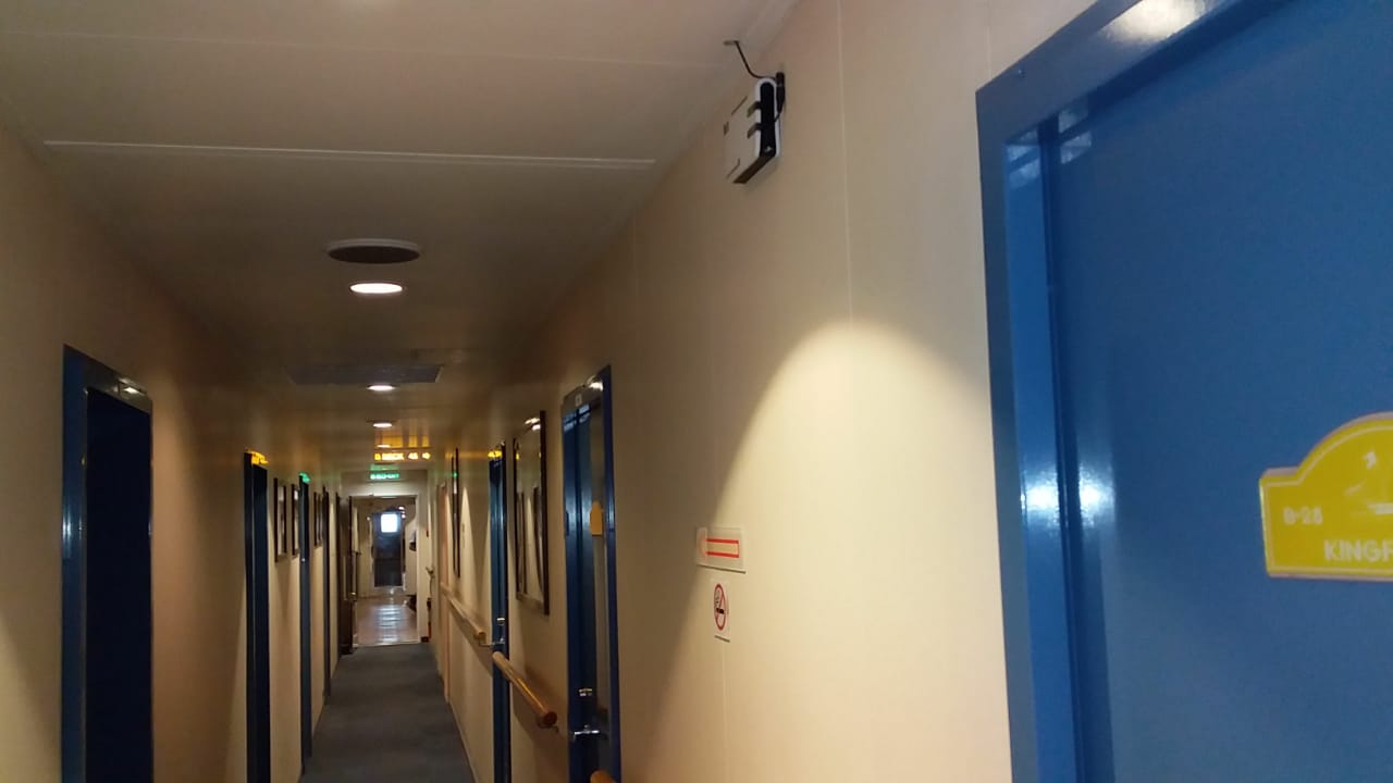 Hallway Signal Booster - Signal repeater mounted in hallway to eliminate dead zones and ensure reliable communication.